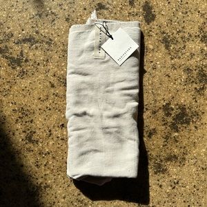 Manifatura beach towel in sand.